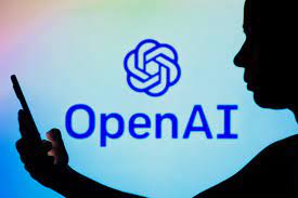 Open AI logo on a gradient background with the silohouette of a person with a phone.